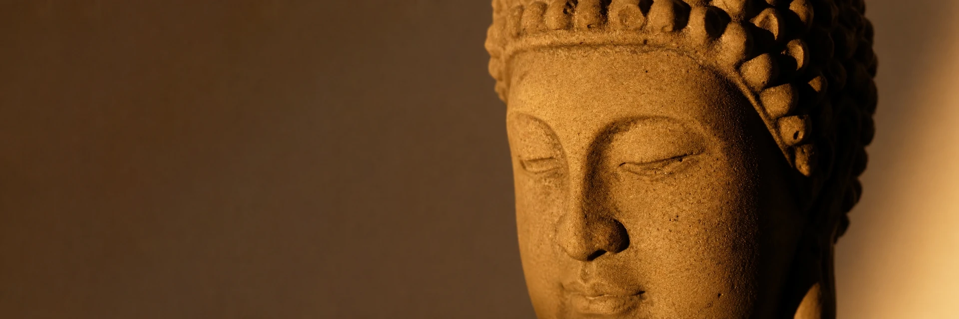 Stone Buddha head in warm golden light